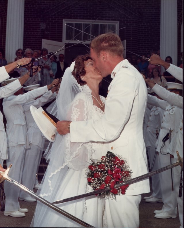 _018_steve_suzette_wedding_sword_arch_kiss.jpg